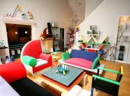 Living room installation filled with bright furniture made from odd shapes. 