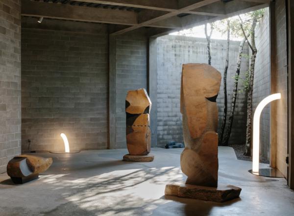 Objects of Common Interest, Tube Light I and Tube Light II, 2019, installed among Isamu Noguchi’s monumental late-career basalt sculptures in The Noguchi Museum’s indoor-outdoor galleries.